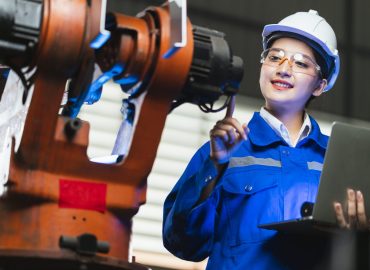 engineer specialist asian female and  technician maintenance inspect relay robot arm system with laptop  to control quality operate process work heavy industry 4.0 manufacturing smart factory