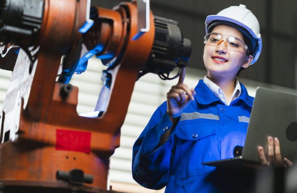 engineer specialist asian female and  technician maintenance inspect relay robot arm system with laptop  to control quality operate process work heavy industry 4.0 manufacturing smart factory