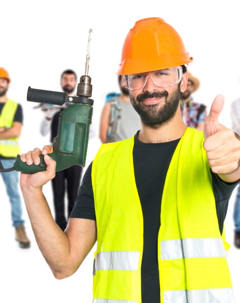 workman with drill over white background